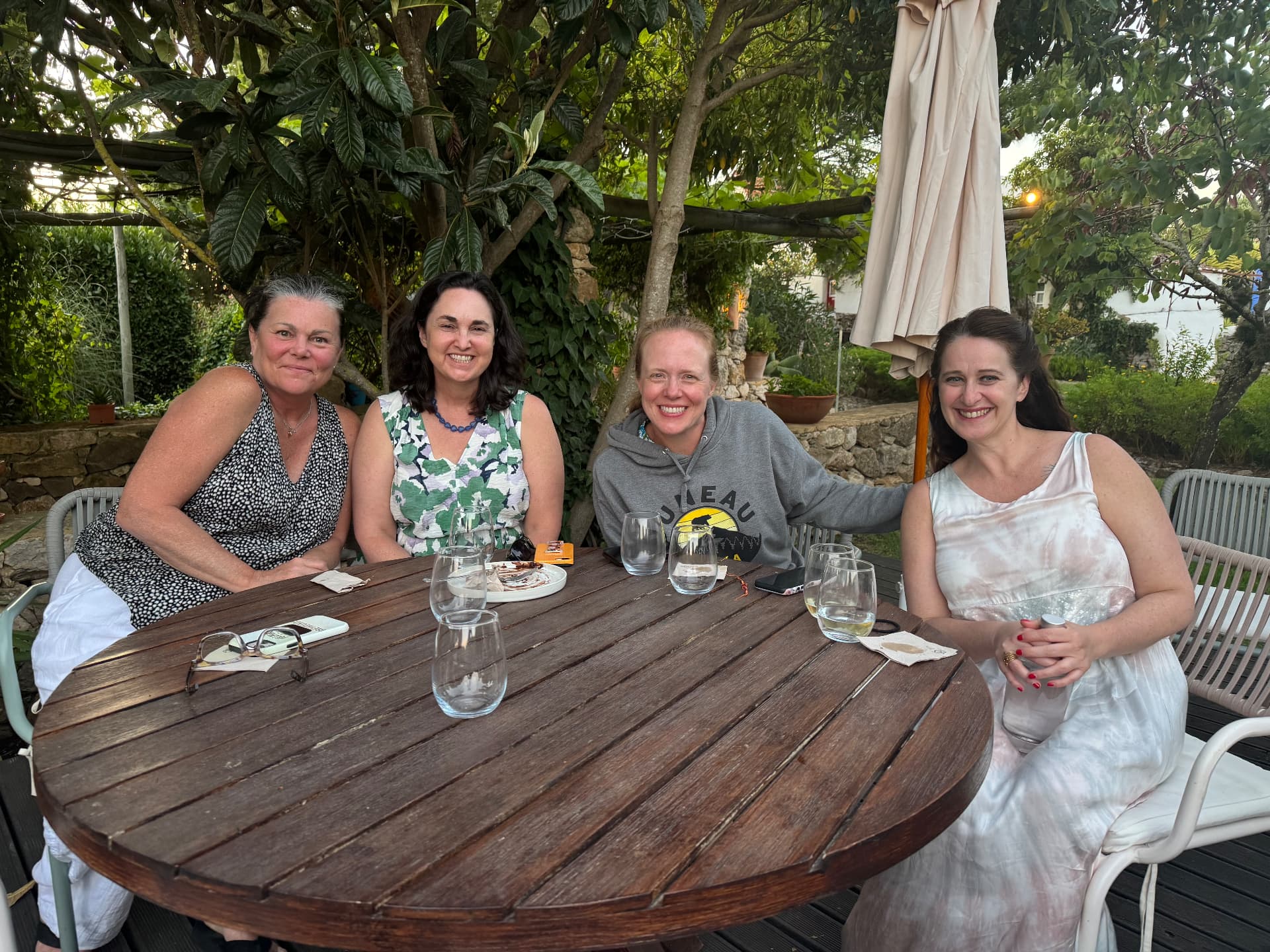 Guests gathered around a garden table after dinner