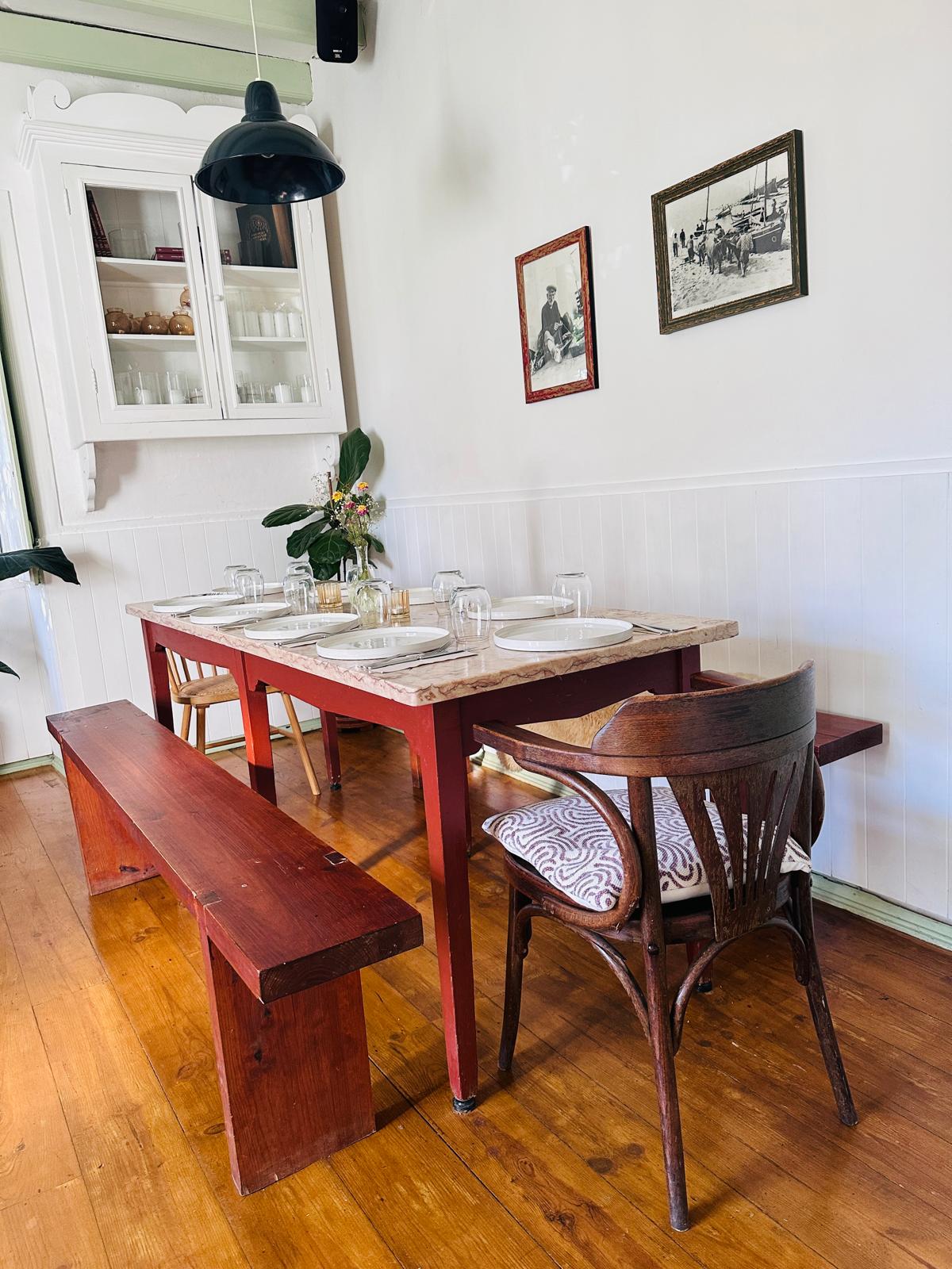 Marble-topped dining table set for a meal in the farmhouse