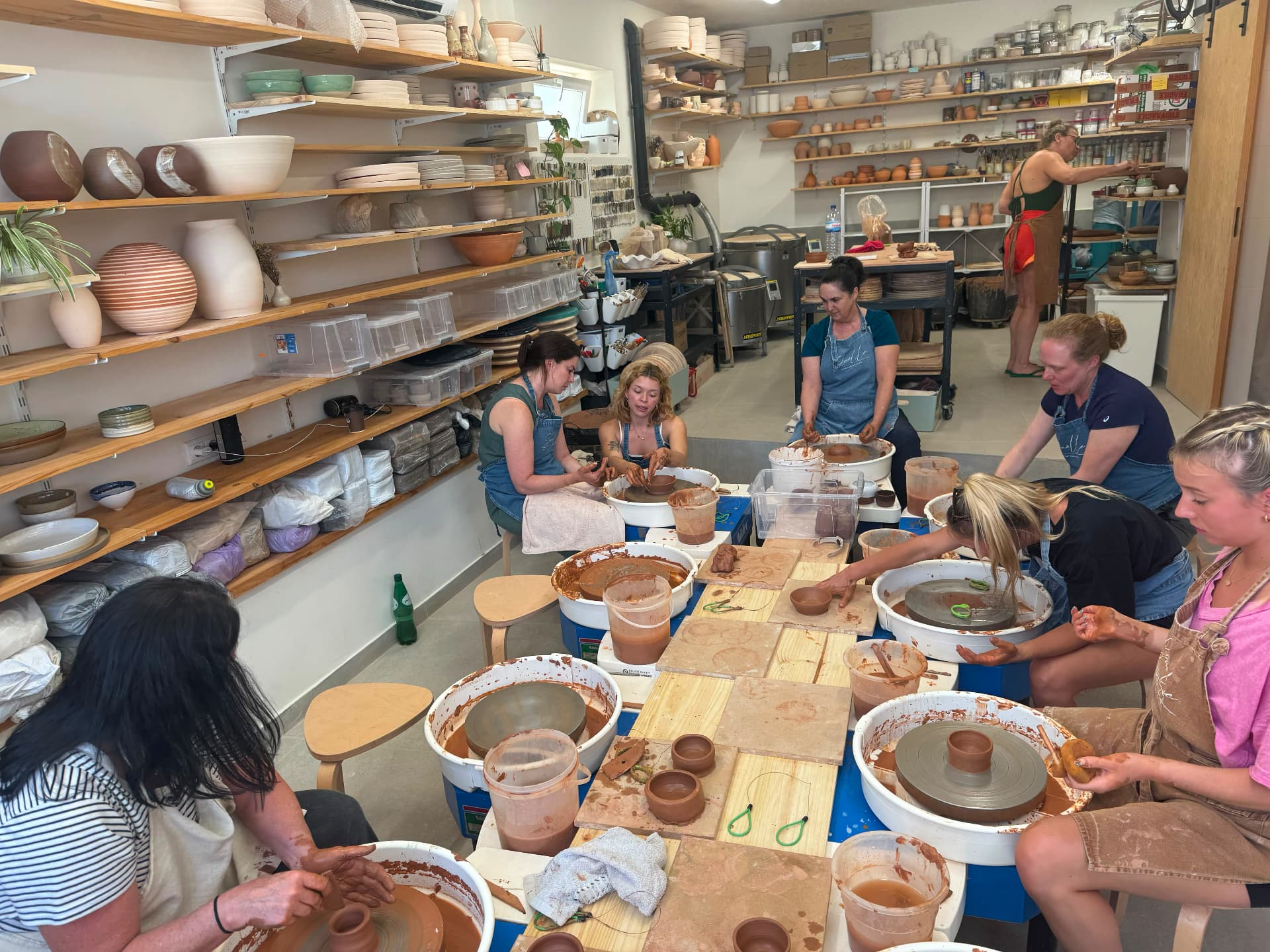 The ceramics studio with guests at the wheels