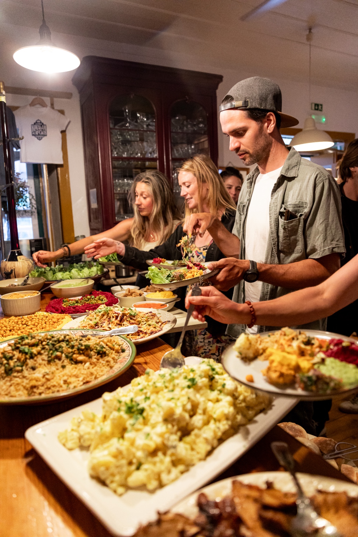 Guests plating a colourful buffet dinner prepared by the on-site chef