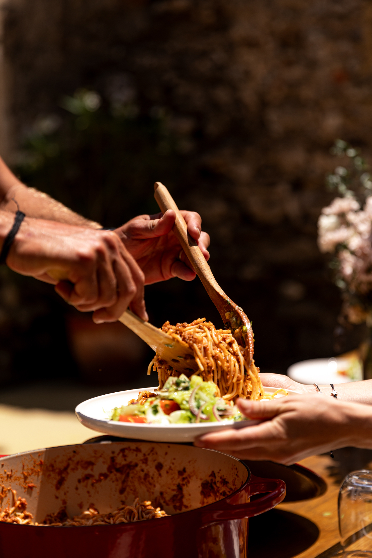 Homemade pasta served family-style in the courtyard