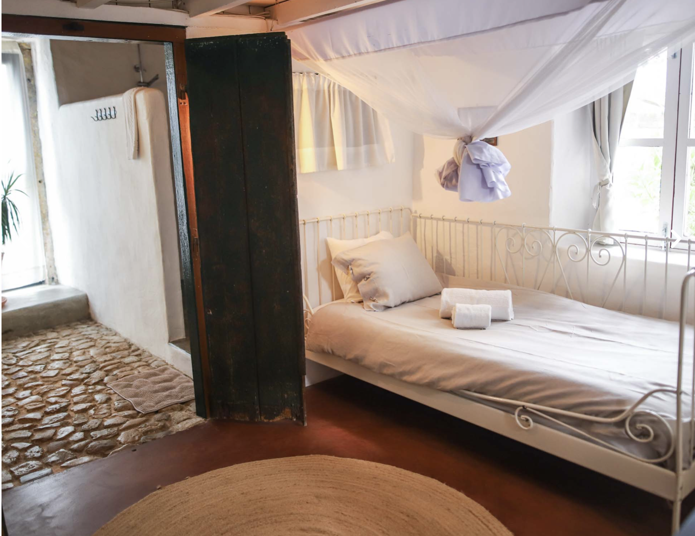 White iron daybed with linen and morning light
