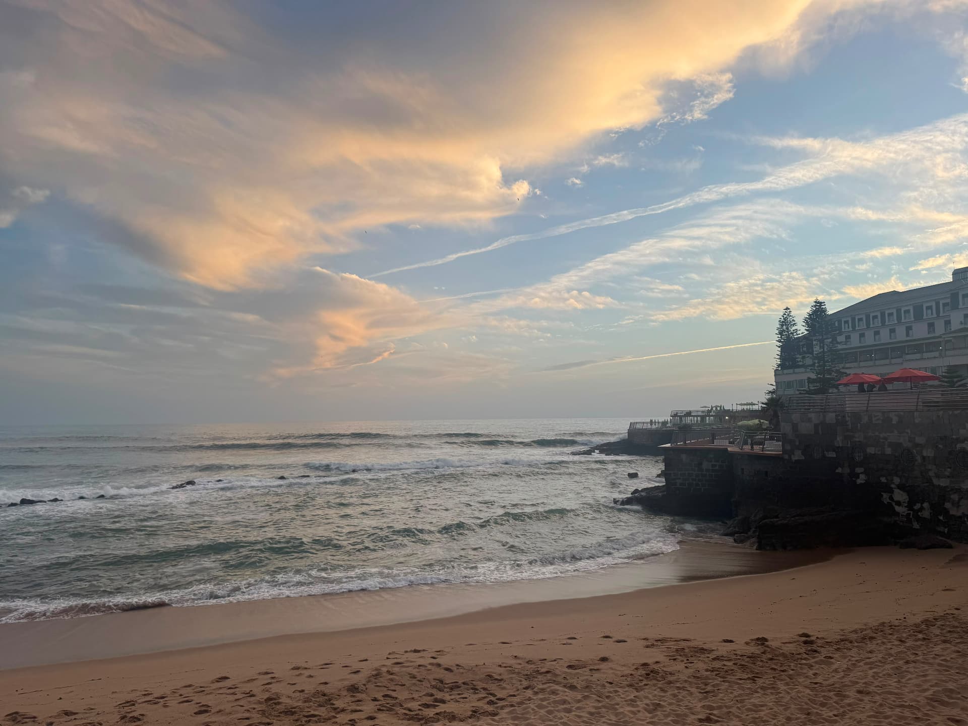 Sunset over the beach and waves at Ericeira