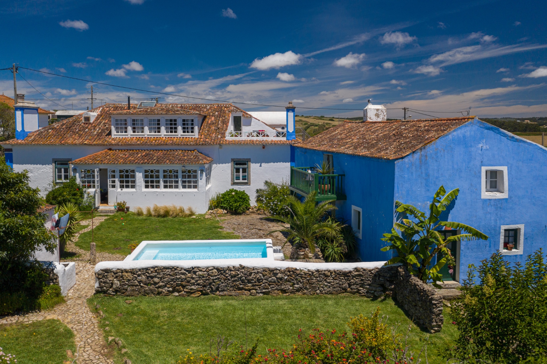 Aerial view of Casa Paco d'Ilhas with the pool and blue outbuilding