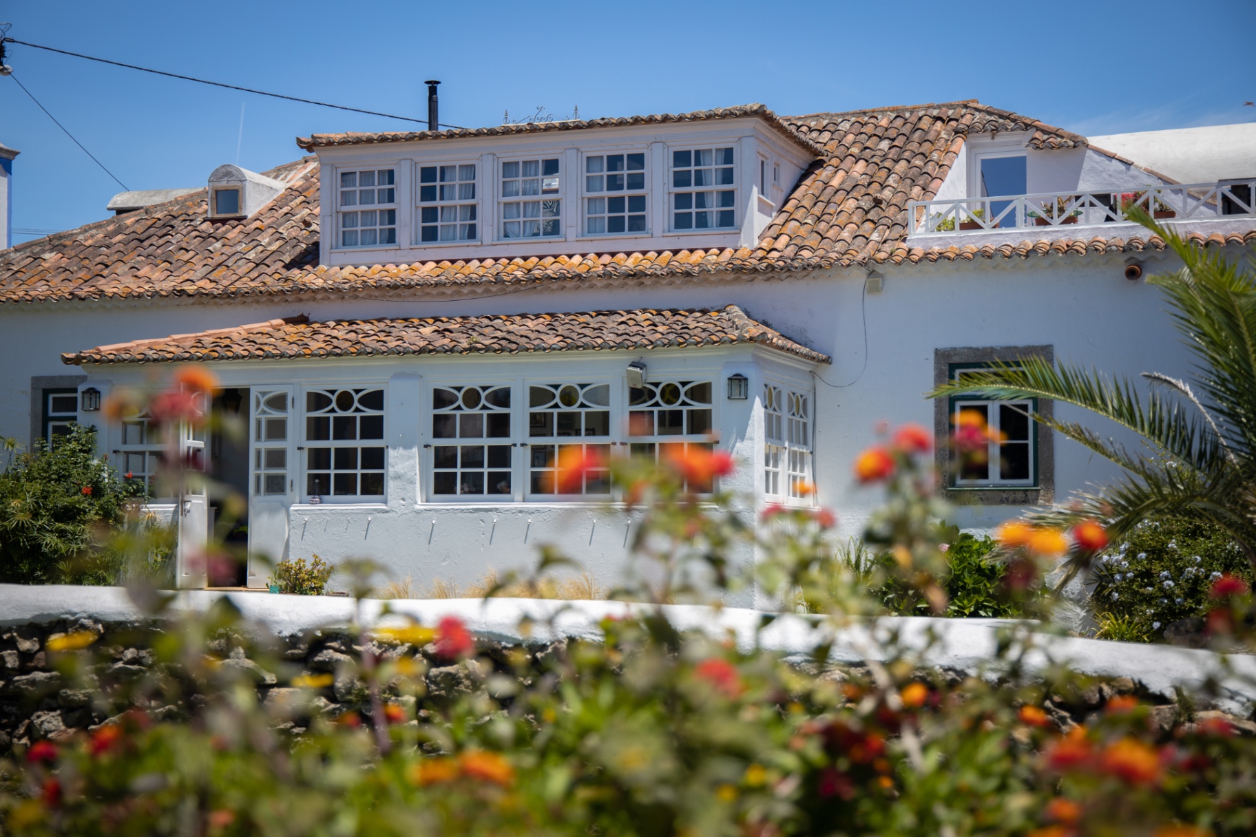 Casa Privada exterior with terracotta roof and blooming garden