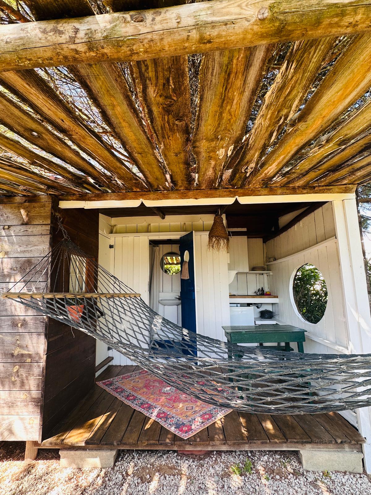 Hammock on the cabana deck under a rustic wooden pergola