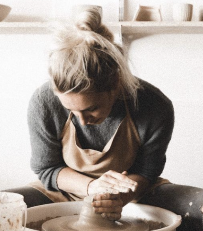 Hands shaping clay at the ceramics workshop