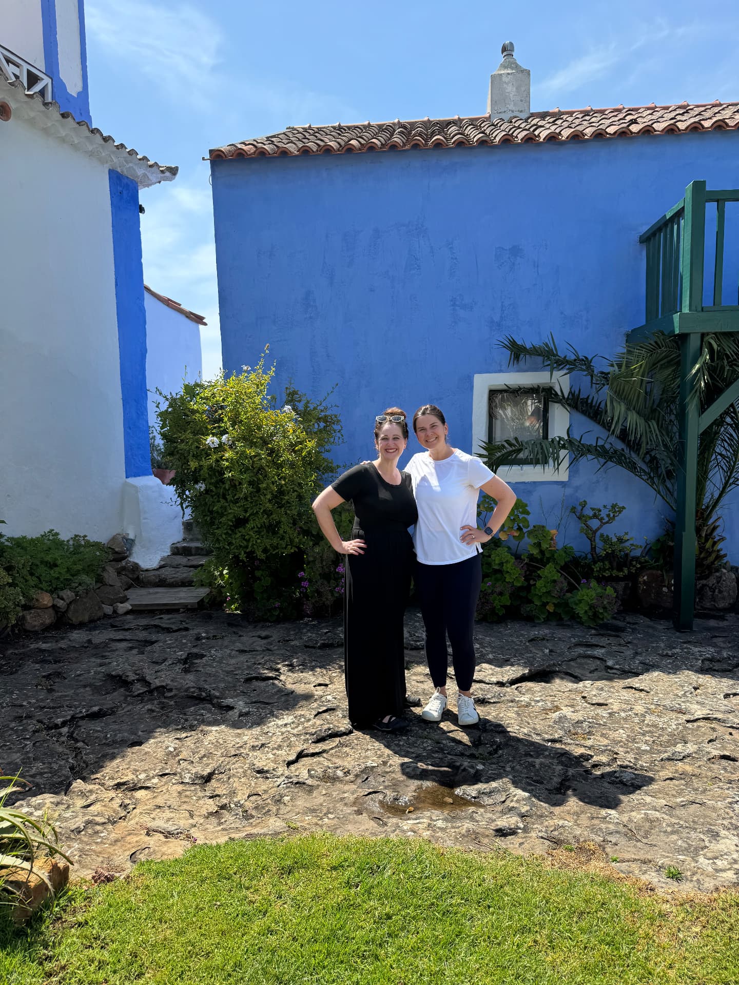 Hosts in the courtyard beside the blue house